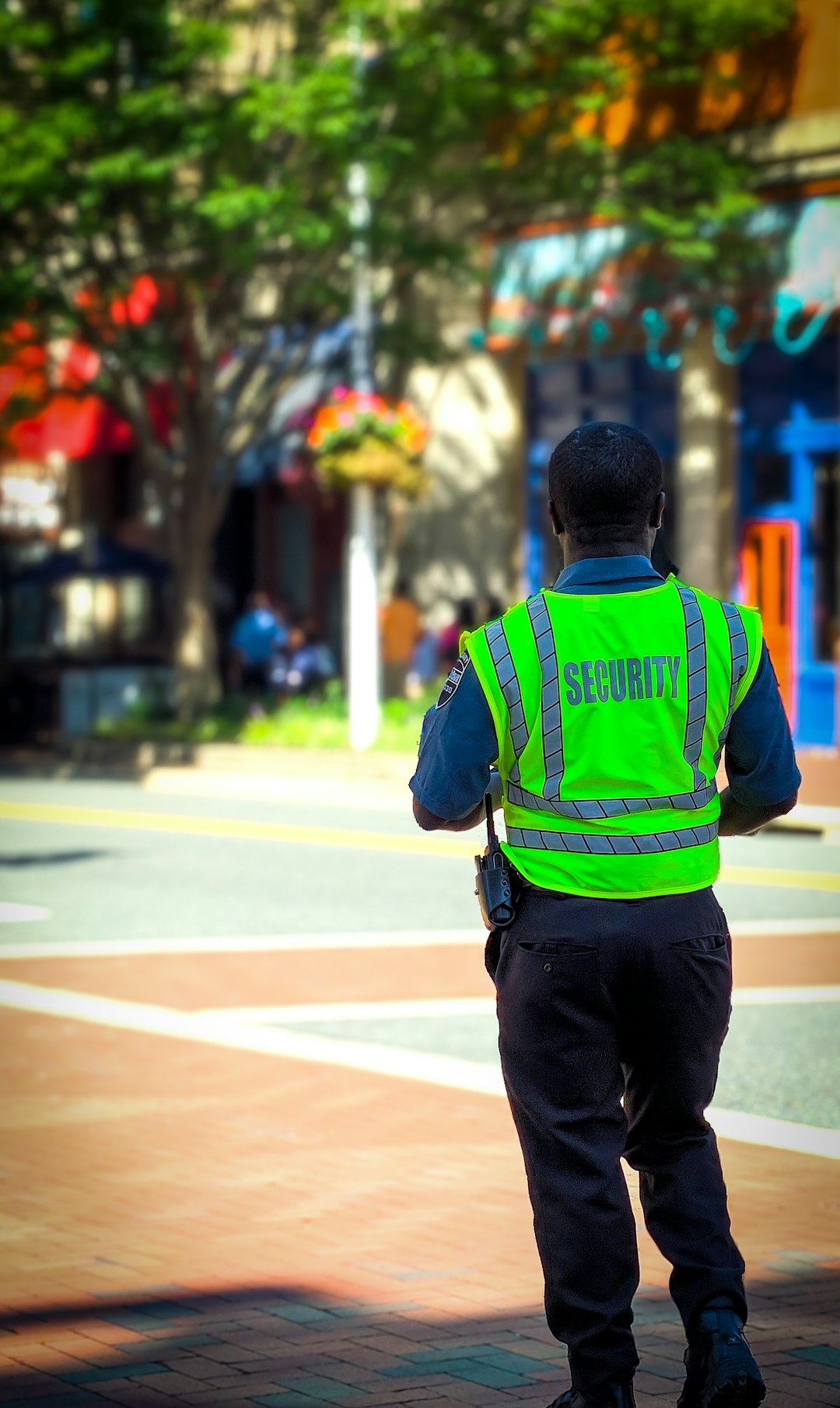Security Guard in a neon green vest watches over a 4way intersection in Shirlington VA.
I miss counted the men Liz!